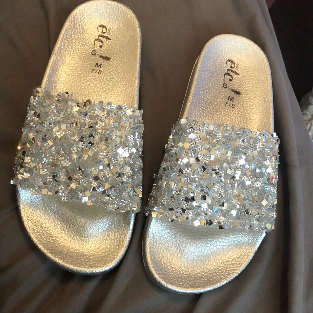 Pair of Sliver colored slide sandals
